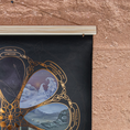 Load image into Gallery viewer, Close-up view of a poster hanger attached to a wall, with part of a poster visible